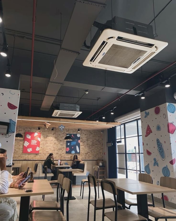 A ceiling with concealed VRF indoor units and air outlet grilles